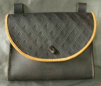 16th - 17th century belt wallet with a  tooled round front and side gussets