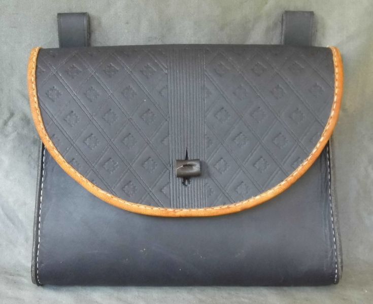 16th - 17th century belt wallet with a  tooled round front and side gussets